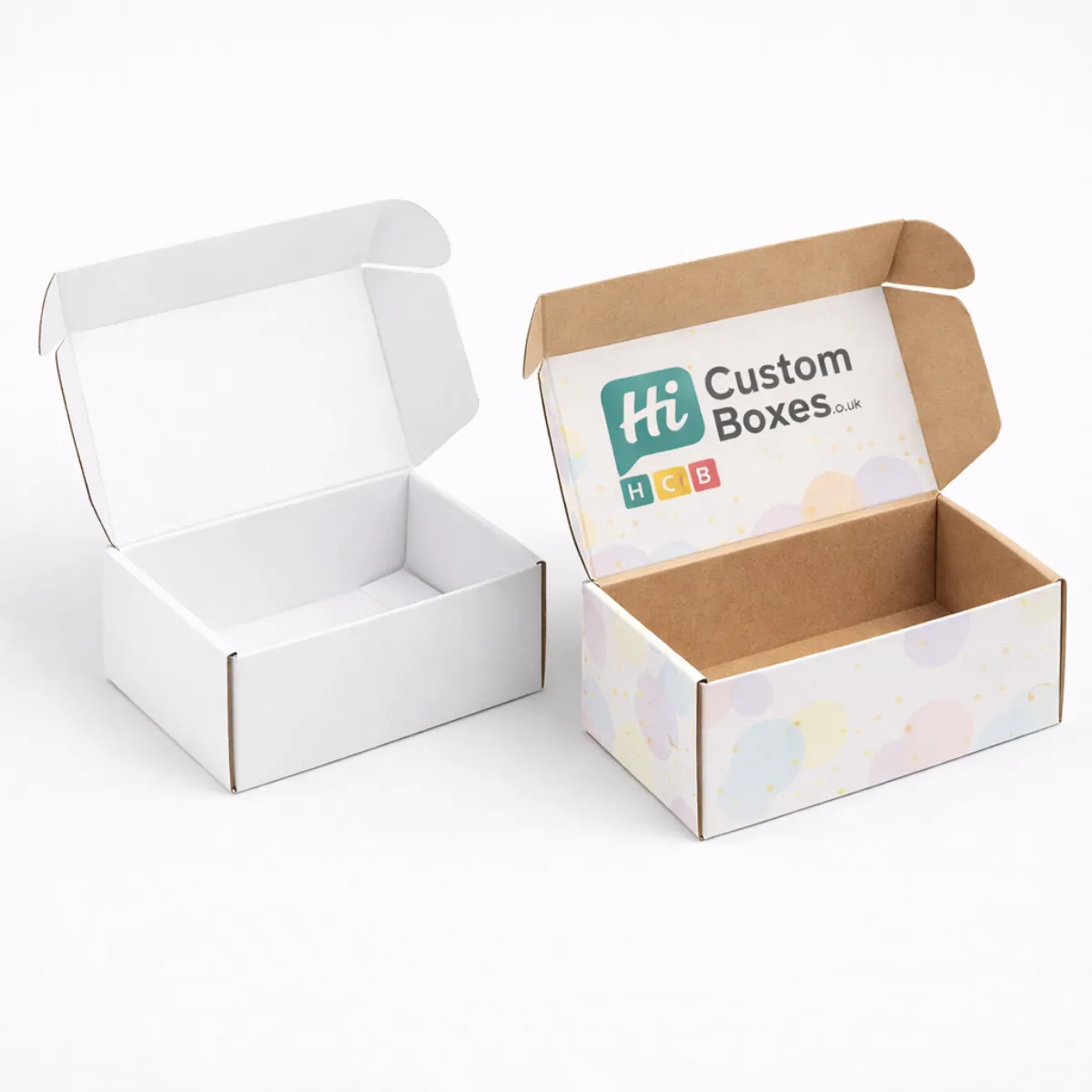Two open cardboard mailer boxes- one white and one featuring a colourful branded internal lid- class=
